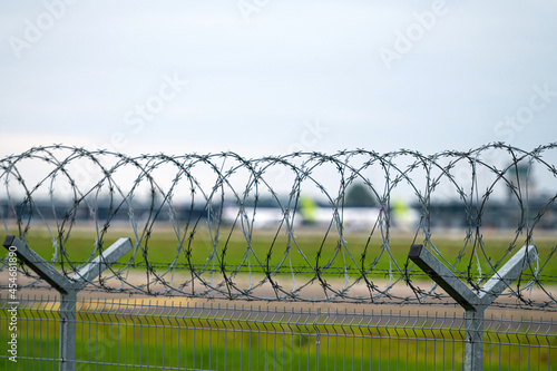 barbed wire fence around the airport area, security barrier, closeup