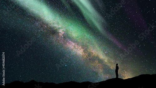 The man stand on a northern light background. time lapse