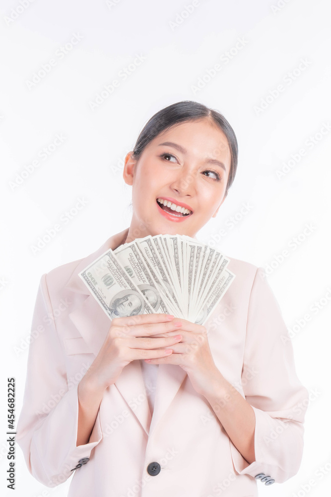 Closeup Successful beautiful Asian business young woman fill happy holding money US dollar bills in hand isolated on white background , business success concept Closeup Successful beautiful Asian business young woman fill happy holding money US dollar bills in hand isolated on white background , business success concept