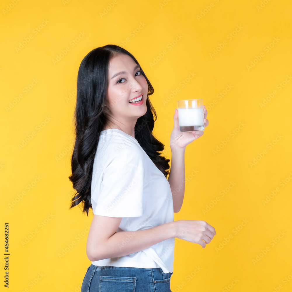 beauty woman Asian cute girl feel happy drinking milk for good health in the morning on yellow background - lifestyle beauty woman healthy concept beauty woman Asian cute girl feel happy drinking milk for good health in the morning on yellow background - lifestyle beauty woman healthy concept