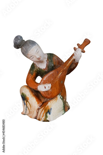 Tri-color figurine, musician isolated on white background with clipping path. Ancient chinese statuette, Tang Dynasty.
