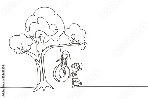 Single one line drawing happy two girls playing tire swing under tree. Cute kids swinging on tire hanging from tree. Children playing in garden. Continuous line draw design graphic vector illustration