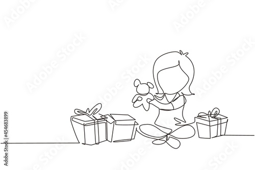 Continuous one line drawing excited little girl kid opening wrapped gift box decorated with ribbon bow. Happy cute little kid girl receive teddy bear gift from birthday. Single line draw design vector