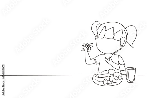 Single continuous line drawing girl eating fruit. Sitting near table eating orange. Watermelon and banana in tray placed on table at home. Healthy food for kids. One line draw graphic design vector
