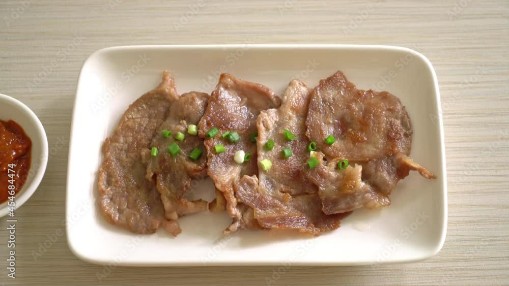 grilled pork neck sliced on plate in Asian style grilled pork neck sliced on plate in Asian style