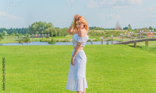 Lady in white cotton suit, crop top and skirt at nature, vacation scene © T.Den_Team