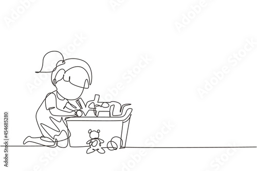 Continuous one line drawing little girl putting her toys into box. Kids doing housework chores at home concept. Smiling child storing her toys in box. Single line design vector graphic illustration