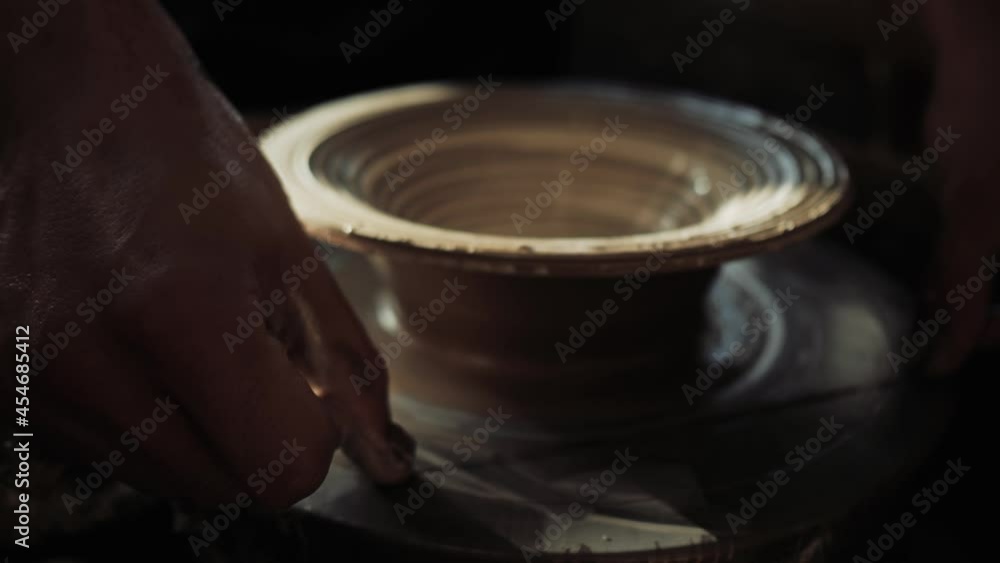 A male potter cuts a ready-made plate from a potter's wheel with a fishing line. High quality 4k footage A male potter cuts a ready-made plate from a potter's wheel with a fishing line. High quality 4k footage