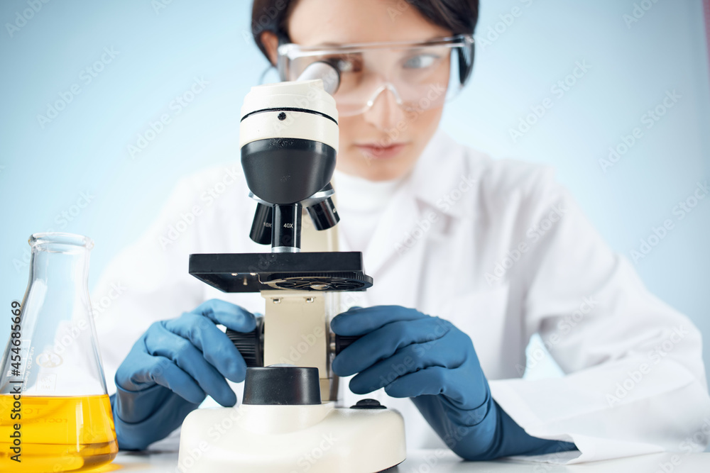 Woman in white coat laboratory microscope work science research Woman in white coat laboratory microscope work science research
