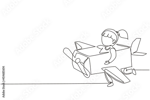 Single continuous line drawing creative girl playing as a pilot with cardboard airplane. Happy kids riding cardboard handmade airplane. Plane game. One line draw graphic design vector illustration