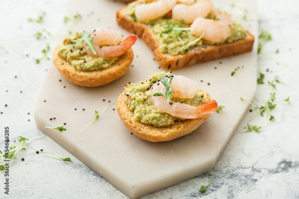 Tasty sandwiches with guacamole and shrimps on light background, closeup Tasty sandwiches with guacamole and shrimps on light background, closeup