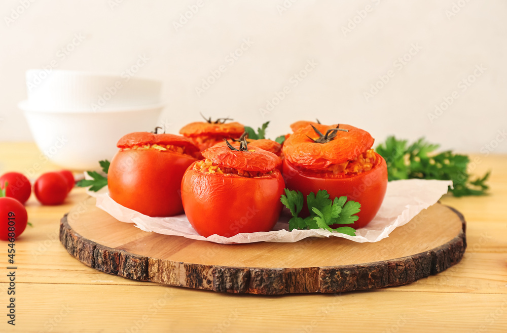 Board with tasty stuffed tomatoes on wooden background Board with tasty stuffed tomatoes on wooden background