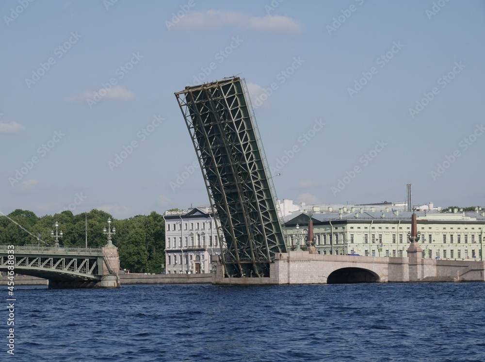 Naklejka premium A Trinity Bridge drawbridge across the Neva River in St. Petersburg on a sunny summer day. A drawbridge connecting Vasilyevsky Island and the central part of the city. 