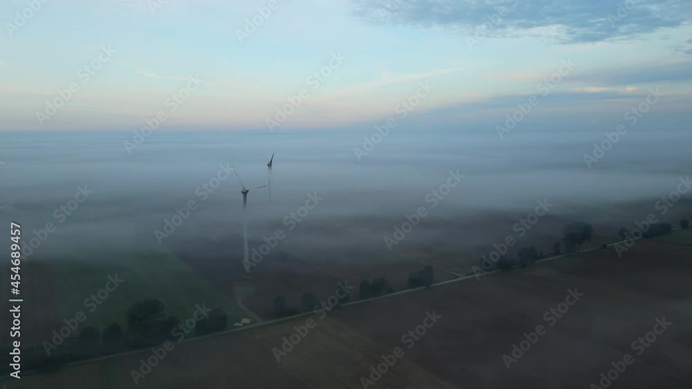 Foggy Landscape Over Wind Farm Turbines On Countryside Of Lubawa, Poland. - Aerial Foggy Landscape Over Wind Farm Turbines On Countryside Of Lubawa, Poland. - Aerial