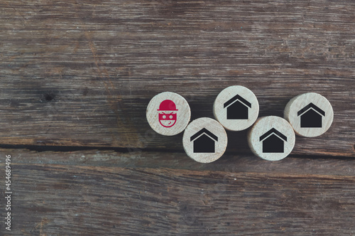 Wooden cube blocks with scammer and house symbols. Real estate scam concept