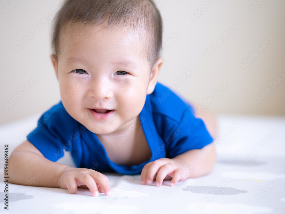 close up a smiling of adorable Asian infant baby girl for tummy time or play time , happy emotion expression of baby close up a smiling of adorable Asian infant baby girl for tummy time or play time , happy emotion expression of baby
