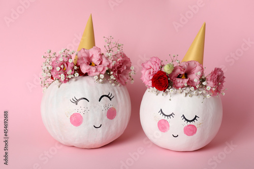 Сute pumpkins with halloween makeup on pink background