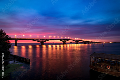 Night river before beautiful sunrise. Light on bridge.