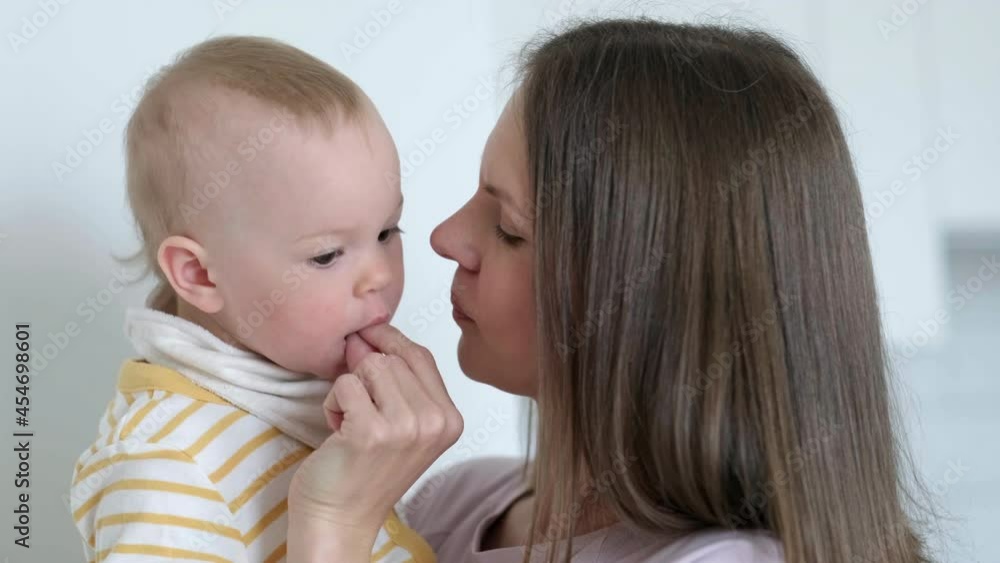 Mom puts vitamin in the childs mouth. eating baby at home. Healthy food, snack or lunch time Mom puts vitamin in the childs mouth. eating baby at home. Healthy food, snack or lunch time