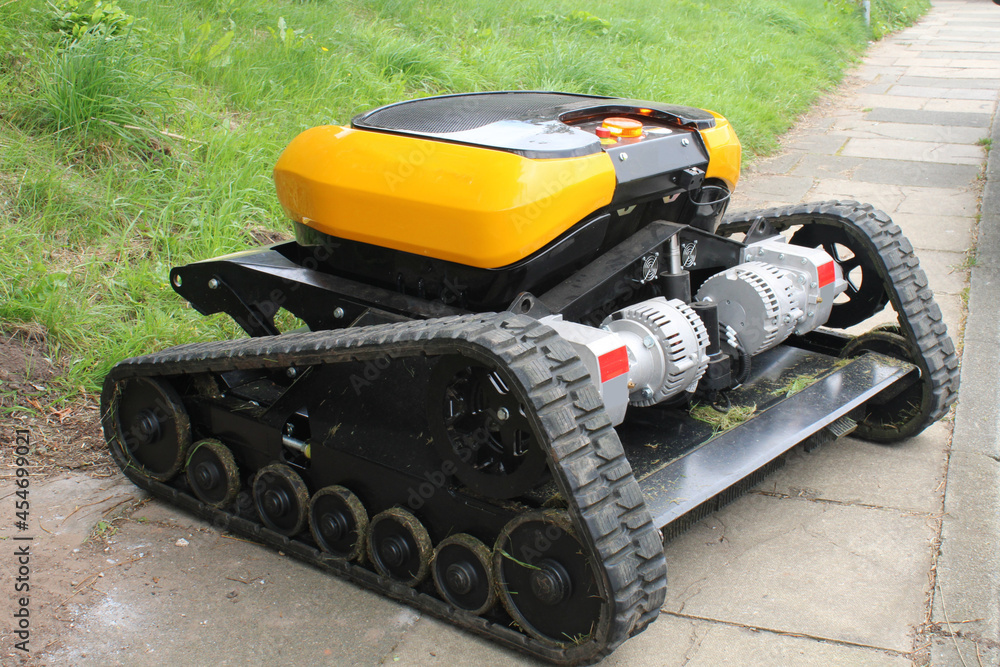 Robotic caterpillar tracked industrial mower, bush cutter. Heavy duty remote controlled lawn mower and bush cutter