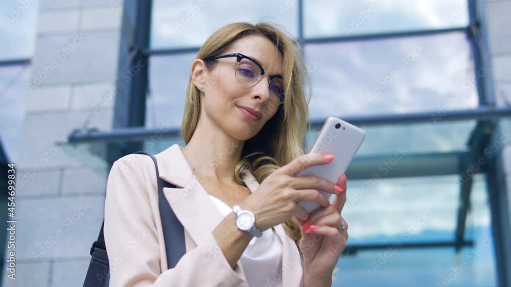 Surprised woman sale-manager checking on smartphone statistics of goods sale. Confident business woman looking at task completion, receiving new orders and projects online. Distant work Surprised woman sale-manager checking on smartphone statistics of goods sale. Confident business woman looking at task completion, receiving new orders and projects online. Distant work