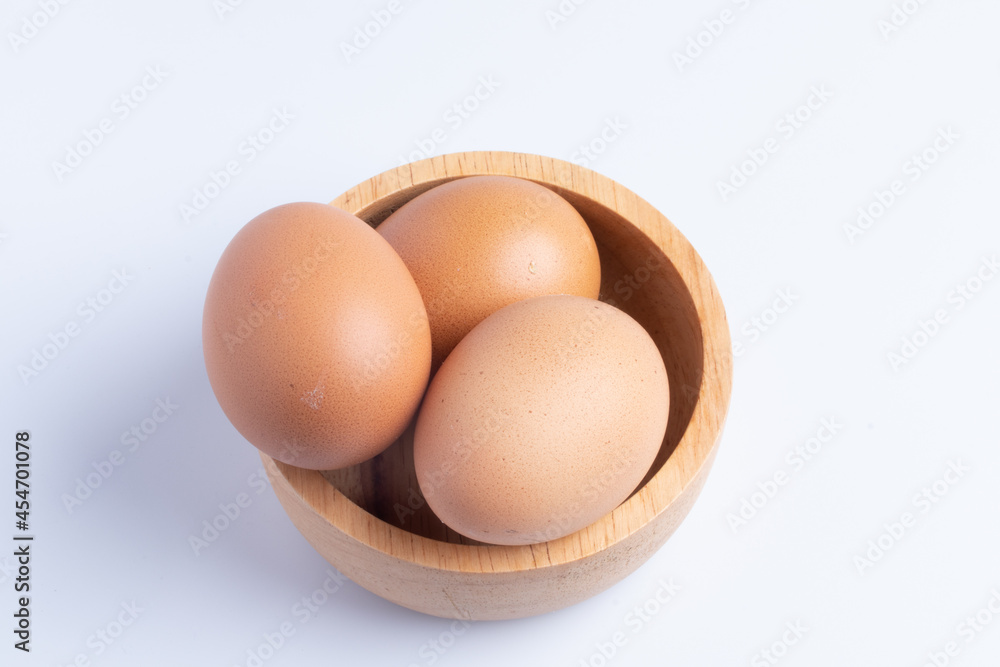 Three fresh eggs in a cup on a white background. Three fresh eggs in a cup on a white background.