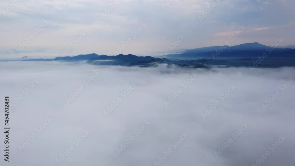 Aerial view Hyper lapse by Drone, Beautiful Landscape in the morning time during sunrise with fog above the mountain, White fluffy clouds moving softly on cloudy, Pang puai Mae moh Lampang, Thailand. Aerial view Hyper lapse by Drone, Beautiful Landscape in the morning time during sunrise with fog above the mountain, White fluffy clouds moving softly on cloudy, Pang puai Mae moh Lampang, Thailand.