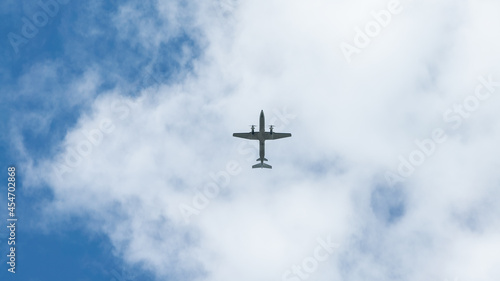 View of propeller plane flying with blue sky and clouds. Airplane fly
