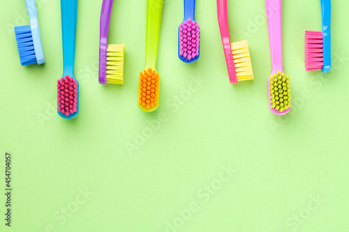 New Toothbrushes Set On Green Paper Background