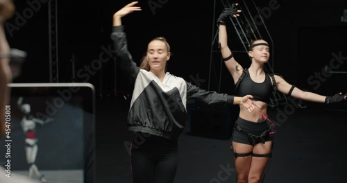 Wallpaper Mural dancing woman wearing motion capture suit rehearsing ballet dance with instructor girl wearing mo-cap suit for 3d character animation for virtual reality technology Torontodigital.ca