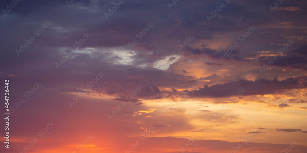Beautiful pink-orange clouds with bright light and purple sky. A beautiful flaming sunset landscape, warm colors, an inspiring concept with space to copy. Heavenly postcard