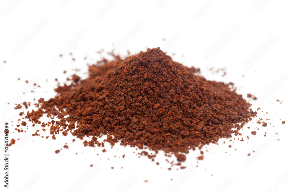 Micro close-up and details of Organic Indian dark brown coffee granules powder (genus Coffea) isolated over white background. Micro close-up and details of Organic Indian dark brown coffee granules powder (genus Coffea) isolated over white background.
