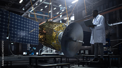 Wallpaper Mural Industrial Engineer Working on Artificial Satellite Construction. Aerospace Agency: African American Scientist Using Tablet Computer to Develop Spacecraft for Space Exploration and Data Communication. Torontodigital.ca