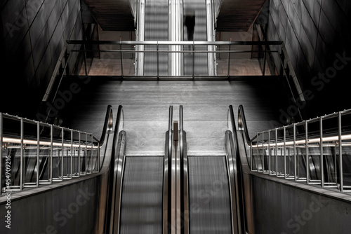 Obraz na płótnie Abstract image with black silhouette on the subway escalator as a symbol of moving forward, getting out of depression, advancing and achieving life goals w salonie