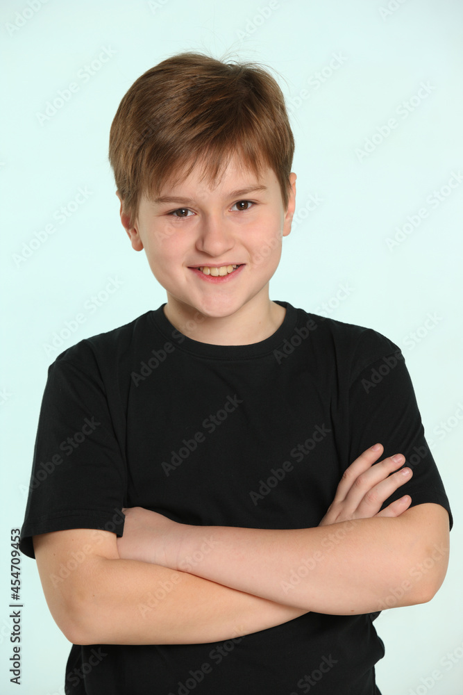 An intelligent teenage boy looks into the eyes with a smile and is sincerely glad of the attention. An intelligent teenage boy looks into the eyes with a smile and is sincerely glad of the attention.