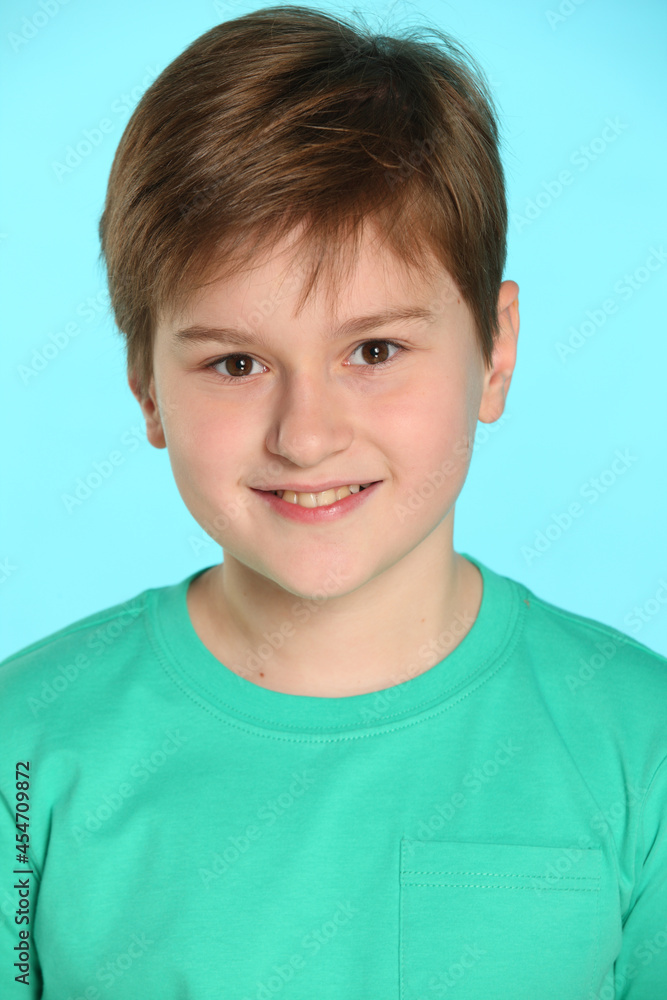 In this portrait of a teenager, a handsome, cheerful young boy looks eye to eye and smiles cheerfully. In this portrait of a teenager, a handsome, cheerful young boy looks eye to eye and smiles cheerfully.