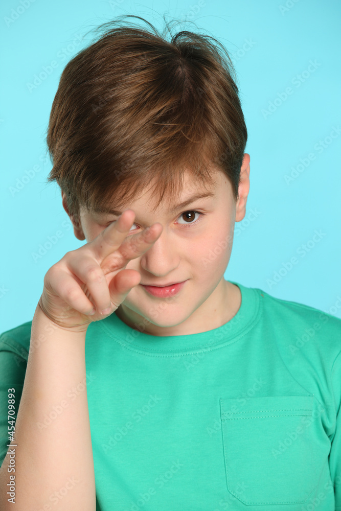 In this portrait, a handsome, cheerful young teenage boy shows that he is watching you. In this portrait, a handsome, cheerful young teenage boy shows that he is watching you.