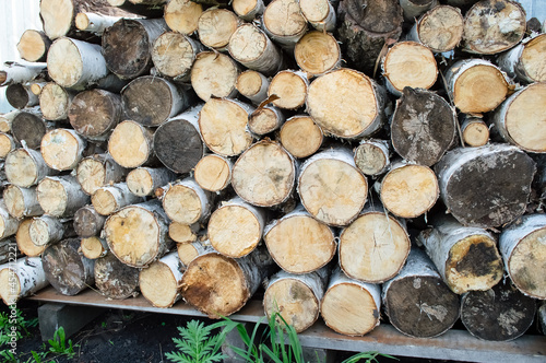 close-up - neatly folded sawn birch firewood  fuel preparation for the winter
