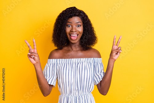 Slika na platnu Portrait of attractive cheerful girl showing double v-sign having fun isolated o
