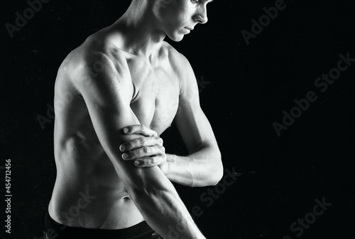 man with dumbbells in hands pumping up muscles exercises