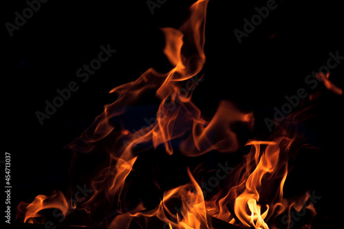Orange flame on black background. Heat energy heap closely, red and yellow