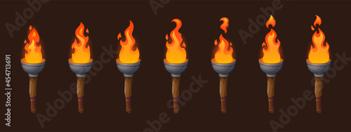 Set of medieval sprite torches with burning fire sequence animation. Ancient wooden brands with flame. Cartoon elements for pc game, flaming torchlight or lighting flambeau isolated vector icons photo