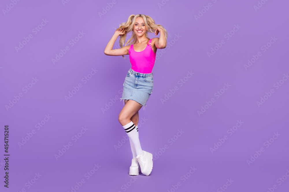 Full length body size view of attractive cheery girl posing making hairdo isolated over bright purple violet color background