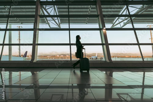Silhouette of female passenger at airport terminal