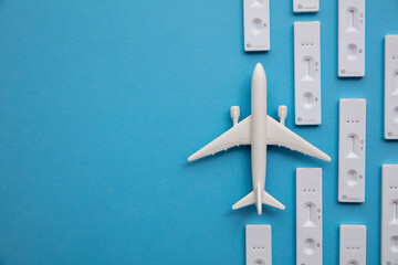 Covid travel concept. Airplane with covid19 antigen test kits