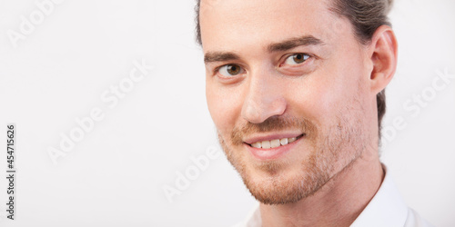Tableau sur toile Close up young handsome manly man portrait with beard, happily smiling and looking in camera