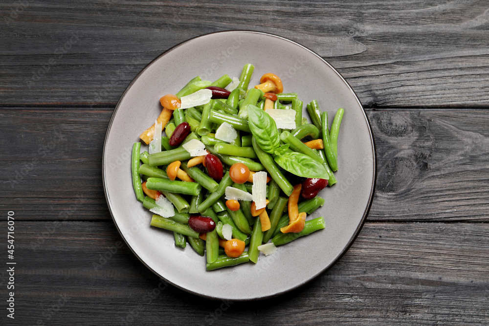Delicious salad with green beans, mushrooms and cheese on black wooden table, top view Delicious salad with green beans, mushrooms and cheese on black wooden table, top view