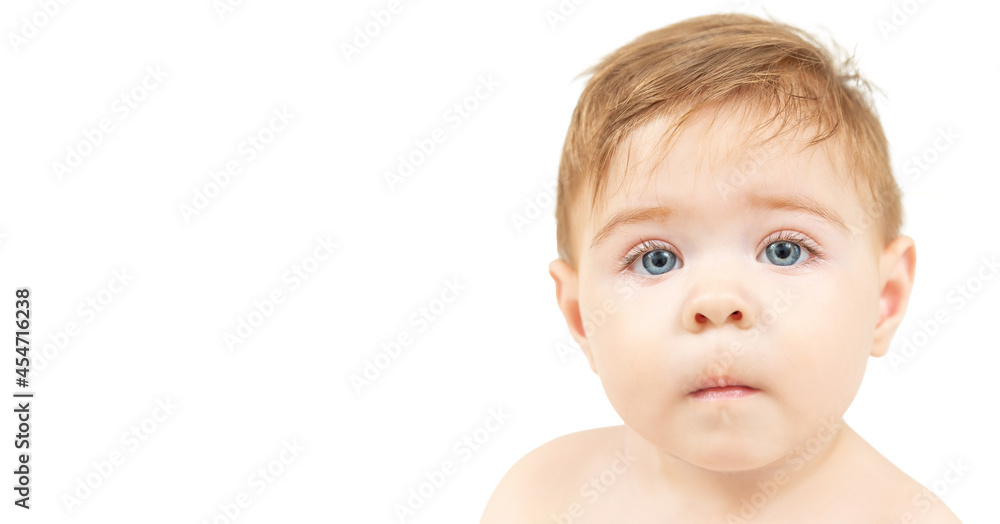 Close-up portrait of a ten-month-old baby boy isolated on white background. Red haired kid looking at camera Close-up portrait of a ten-month-old baby boy isolated on white background. Red haired kid looking at camera