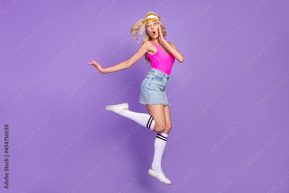 Full size profile side photo of young girl amazed shocked surprised jump isolated over purple color background Full size profile side photo of young girl amazed shocked surprised jump isolated over purple color background