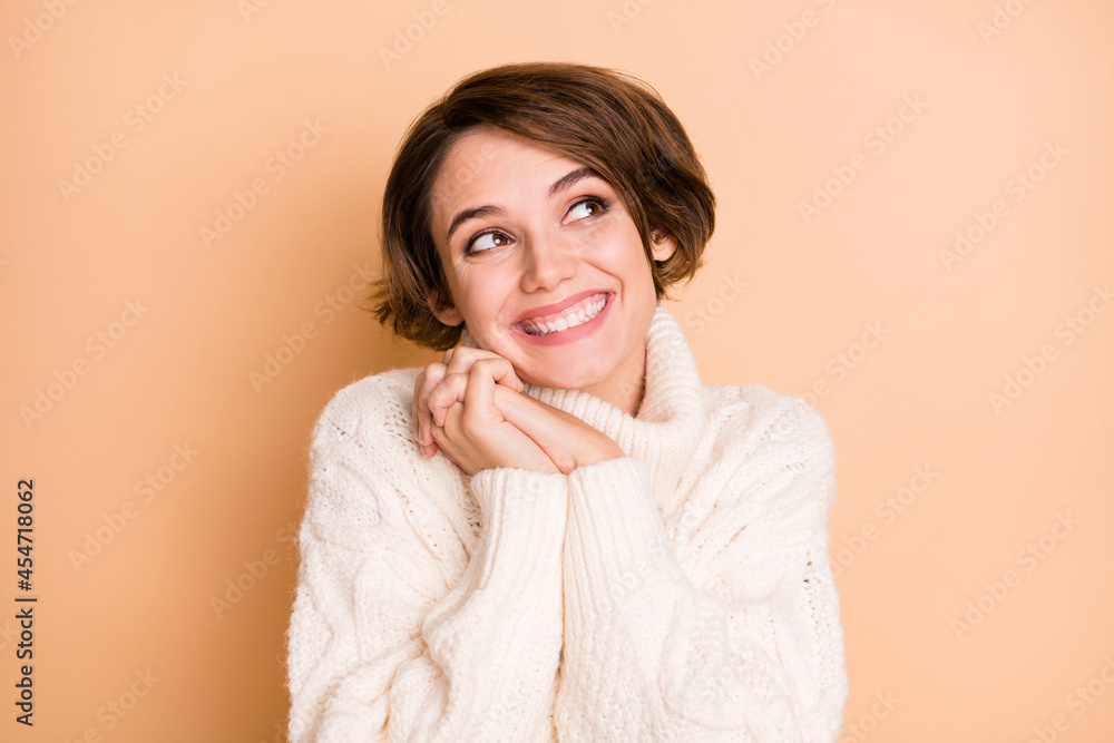 Photo of charming dreamy cute lady look empty space imagine present hands together isolated on beige color background Photo of charming dreamy cute lady look empty space imagine present hands together isolated on beige color background